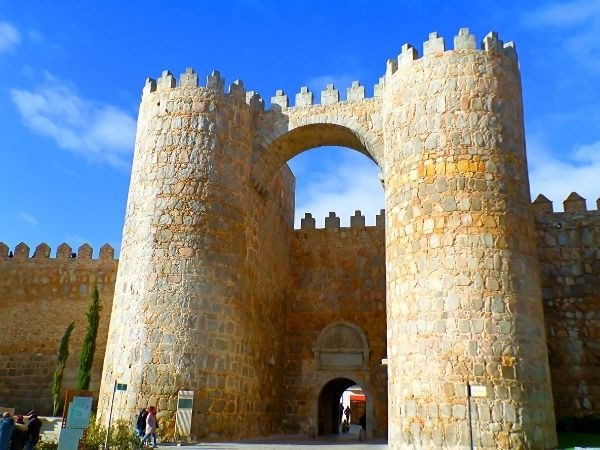 Historic Puerta de San Andrés entrance gate to the ancient walled city of Segovia, Spain, featuring medieval stone towers and archway on a sunny day
