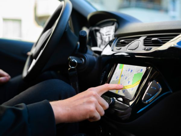 Driver using GPS navigation system to explore Mallorca roads after renting a car in Playa de Muro