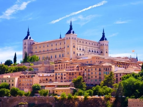 Alcazar de Toledo Spain castle overlooking the historic city of Toledo, panoramic view of the ancient fortress on the hill with dramatic sky