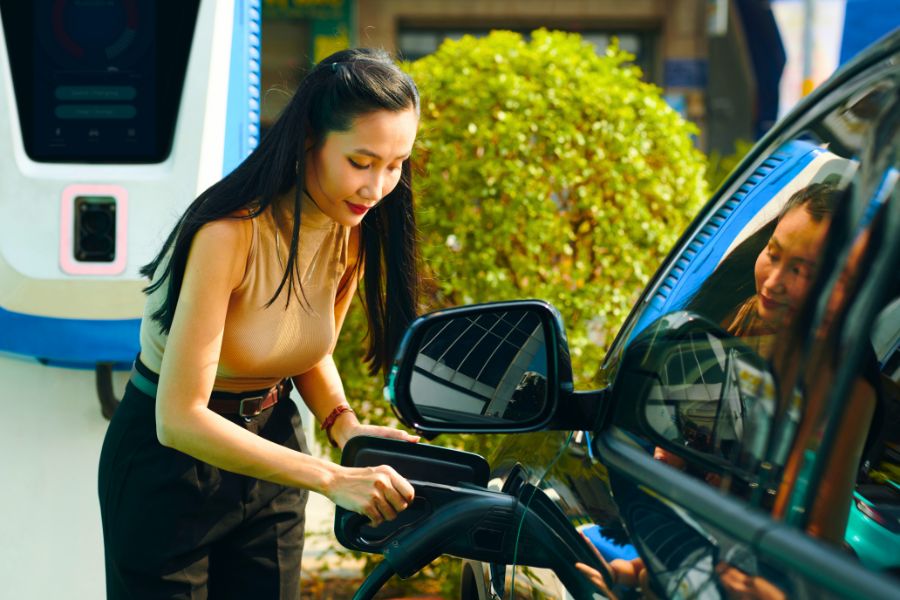 Woman with an Electric Car